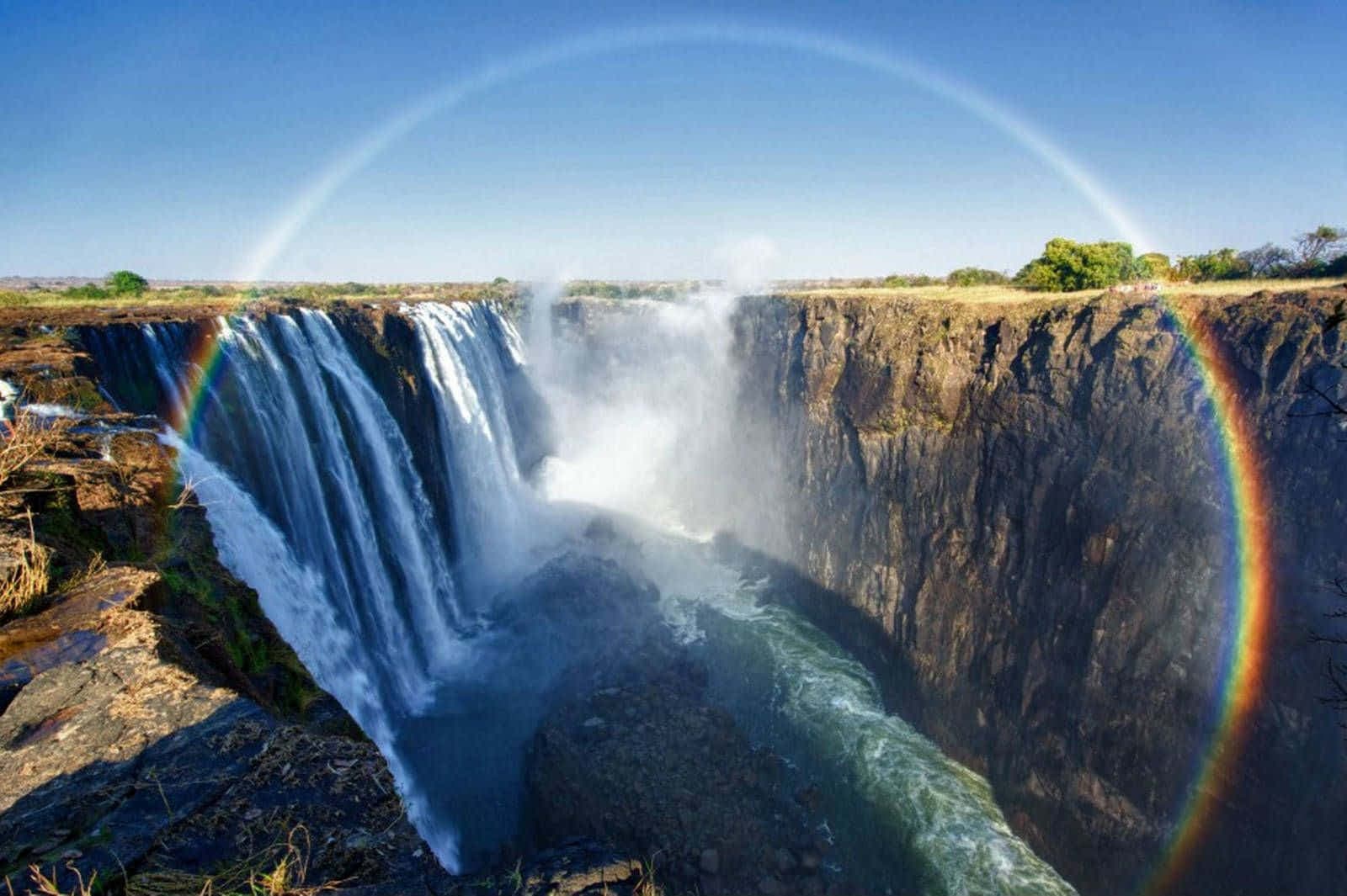 Victoria Falls with rainbow mist over the gorge